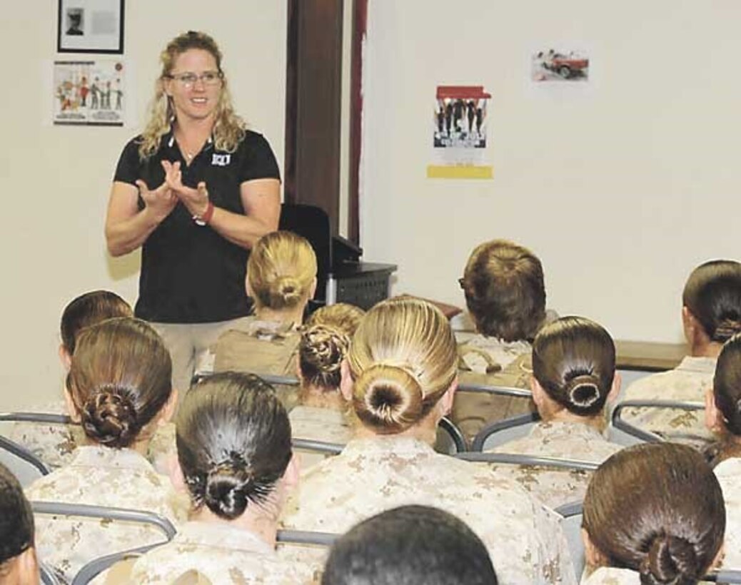 Coach Andrea Hudy, University of Kansas assistant athletic director for sport performance, talks with female Marines about leadership during a visit last week.