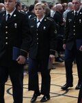 Army Pvt. Jennifer H. Roberts, center, marches out of the National Guard Patriot Academy gymnasium following the graduation ceremony of Class 12-01, Nov. 4, 2011 at the Muscatatuck Urban Training Complex in Butlerville, Ind. Roberts said that it was the Patriot Academy who gave her not a second, but a third chance to turn her life around and realize her potential.