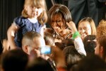 First Lady Michelle Obama greets a crowd of National Guard and local families during a Joining Forces community event in the Veterans Memorial Auditorium in Columbus, Ohio, April 14, 2011. The national initiative she launched with Dr. Jill Biden, wife of Vice President Joe Biden, calls on all sectors of society to honor and support military families.