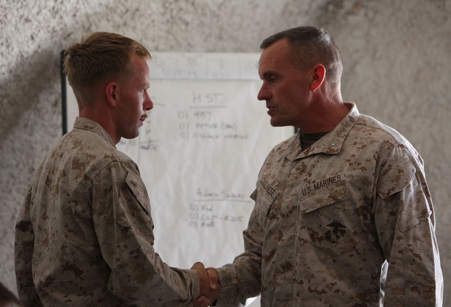 Brigadier Gen. Vincent A. Coglianese, commanding general of 1st Marine Logistics Group, shakes hands with Cpl. Thomas Evans, a squad leader with Combat Logistics Battalion 11, Combat Logistics Regiment 17, 1st MLG, for his hard work and discipline as squad leader at Marine Corps Air Ground Combat Center, Calif., Aug. 9, 2013. Coglianese came aboard MCAGCC to observe the battalion’s field exercise. 
