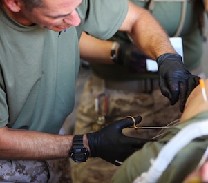 Lieutenant Cmdr. Daniel Trueba, an emergency medicine physician with Combat Logistics Regiment 17, 1st Marine Logistics Group, carefully stitches a role-player’s wound during a mass casualty exercise at Marine Corps Air Ground Combat Center, Calif., Aug. 9, 2013. Over the three-day exercise, corpsmen taking part in the training evolution received difficult scenarios in which they applied lifesaving skills to simulated casualties.
