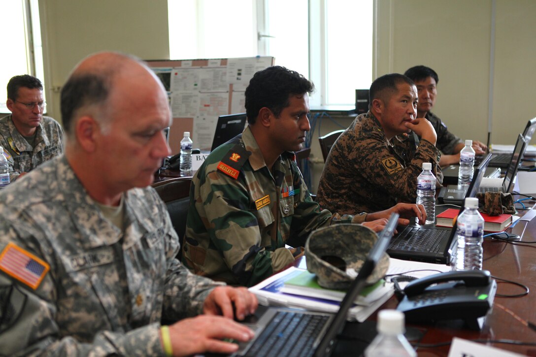 Command post exercise (CPX) participants from the U.S., India, Mongolia and the Republic of Korea, listen as they receive instructions from their executive officer, Aug. 12. Khaan Quest, a multinational peacekeeping exercise hosted annually by the Mongolian Armed Forces and co-sponsored by U.S. Marine Corps Forces Pacific and U.S. Army Pacific, is the latest in a continuing series of exercises designed to promote regional peace and security. MARFORPAC is the U.S. executive for this year’s exercise, which has been taking place since 2003. Khaan Quest 2013 officially ended Aug. 14.