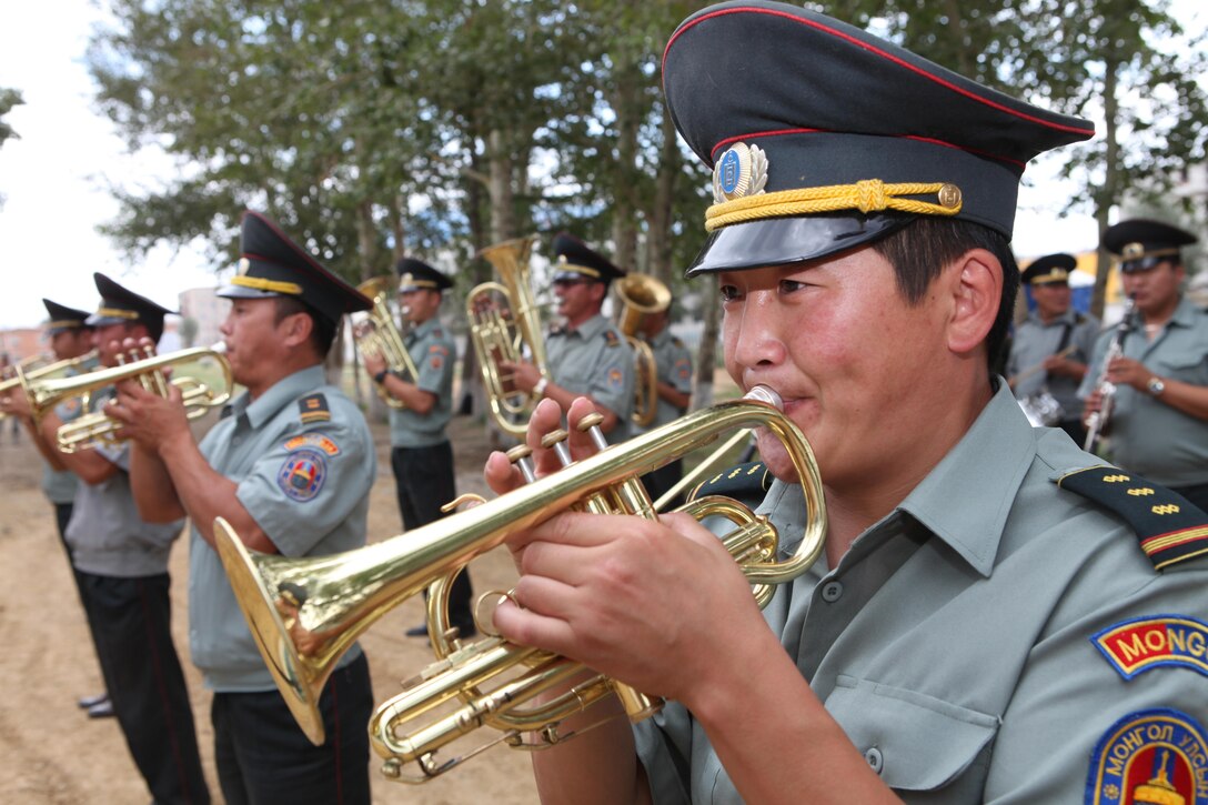 Members of the 014 Engineer Unit Ceremonial Band play traditional Mongolian military music prior to the start of the ribbon-cutting ceremony for the newly renovated Erdmiin Orgil School in Nalaikh district, Ulaanbaatar, Mongolia, Aug. 13. The project took place as part of exercise Khaan Quest 2013. Engineers from the U.S., Mongolia and Canada worked side-by-side to replace the roof, windows, front stairs and interior doors, "re-stucco" the exterior walls, apply emulsion and repaint the building. They also tore down a structurally unsound concrete awning at the main entrance and built a handicap-accessible ramp at the front of the school. 