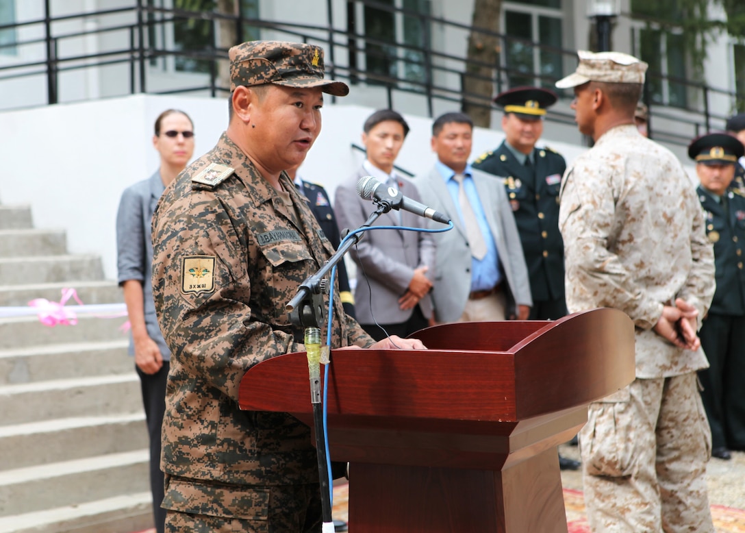 Maj. Gen. B. Bayarmagnai, deputy chief of general staff for the Mongolian Armed Forces, addresses local residents, members of the Mongolian media and multinational troops during a ribbon-cutting ceremony for the newly renovated Erdmiin Orgil School in Nalaikh district, Ulaanbaatar, Mongolia, Aug. 13. The project took place as part of exercise Khaan Quest 2013. Engineers from the U.S., Mongolia and Canada worked side-by-side to replace the roof, windows, front stairs and interior doors, "re-stucco" the exterior walls, apply emulsion and repaint the building. They also tore down a structurally unsound concrete awning at the main entrance and built a handicap-accessible ramp at the front of the school.