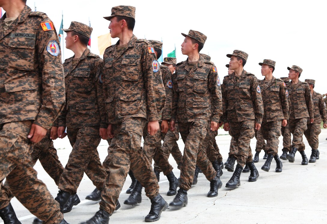 Mongolian Armed Forces soldiers march past an international delegation during the closing ceremony for exercise Khaan Quest 2013, Aug. 14. The multinational peacekeeping exercise is hosted annually by the Mongolian Armed Forces and co-sponsored by U.S. Marine Corps Forces Pacific and U.S. Army Pacific, and designed to promote regional peace and security. The intent of Khaan Quest 2013 was to enhance military-to-military interoperability in peacekeeping operations and increase multinational cooperation. In addition to Mongolia and the United States, military personnel from Australia, Canada, France, Germany, Japan, India, Nepal, South Korea, Tajikistan, United Kingdom and Vietnam also participated in the exercise. MARFORPAC served as the U.S. executive agent for this year’s exercise.