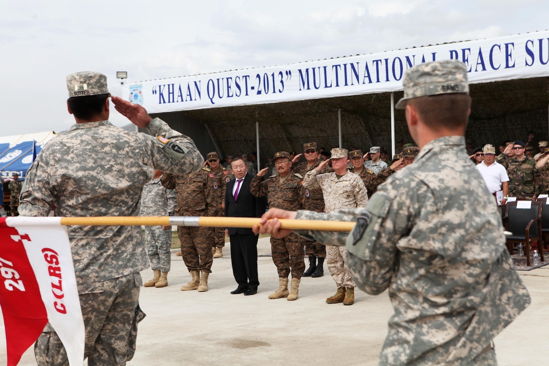 Soldiers with the 297th Battlefield Surveillance Brigade, Alaska Army National Guard, march past an international delegation during the closing ceremony for exercise Khaan Quest 2013, Aug. 14. Lt. Gen. Terry G. Robling (right), commander of U.S. Marine Corps Forces Pacific, was the senior-ranking U.S. military official to attend the ceremony. Khaan Quest, a multinational peacekeeping exercise hosted annually by the Mongolian Armed Forces and co-sponsored by U.S. Marine Corps Forces Pacific and U.S. Army Pacific, and designed to promote regional peace and security. The intent of Khaan Quest 2013 was to enhance military-to-military interoperability in peacekeeping operations and increase multinational cooperation. In addition to Mongolia and the United States, military personnel from Australia, Canada, France, Germany, Japan, India, Nepal, South Korea, Tajikistan, United Kingdom and Vietnam also participated in the exercise. MARFORPAC served as the U.S. executive agent for this year’s exercise.