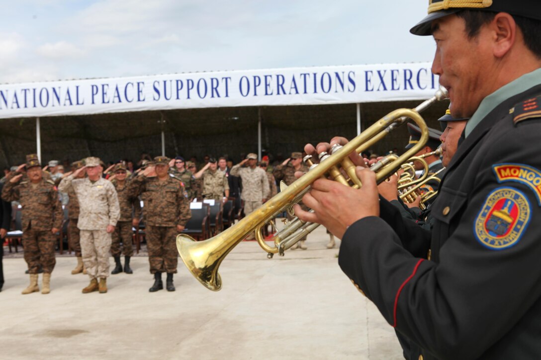 Members of a Mongolian Armed Forces ceremonial band march past an international delegation during the closing ceremony for Khaan Quest 2013, Aug. 14. The multinational peacekeeping exercise is hosted annually by the Mongolian Armed Forces and co-sponsored by U.S. Marine Corps Forces Pacific and U.S. Army Pacific, and designed to promote regional peace and security. The intent of Khaan Quest 2013 was to enhance military-to-military interoperability in peacekeeping operations and increase multinational cooperation. In addition to Mongolia and the United States, military personnel from Australia, Canada, France, Germany, Japan, India, Nepal, South Korea, Tajikistan, United Kingdom and Vietnam also participated in the exercise. MARFORPAC served as the U.S. executive agent for this year’s exercise.
