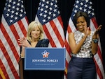 Dr. Jill Biden speaks about the White House's "Joining Forces" military family support campaign to a crowd of National Guard and local families as First Lady Michelle Obama stands by during a community event in the Veterans Memorial Auditorium in Columbus, Ohio, April 14, 2011.
