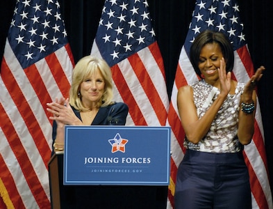 Dr. Jill Biden speaks about the White House's "Joining Forces" military family support campaign to a crowd of National Guard and local families as First Lady Michelle Obama stands by during a community event in the Veterans Memorial Auditorium in Columbus, Ohio, April 14, 2011.