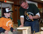 Greg Stevens (right), 4-H community educator, helps Dokota Mattern, 8, build a bluebird house during a natural resource lab as part of the N.Y. National Guard Family and Youth Training Workshop, April 16, 2011. The N.Y. National Guard Youth program provides support and skills training in leadership, mentoring and resource coordination that reflect the unique needs of military children.