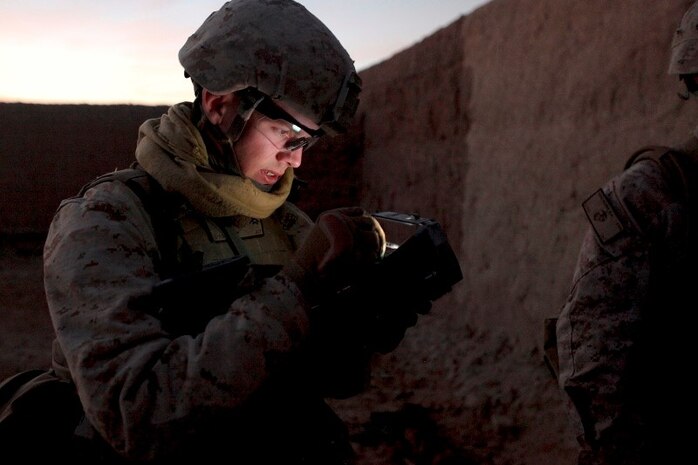Lance Cpl. Kevin Romero gathers information from suspected insurgents and inputs the information into the unit's SEEK machine. The SEEK is a biometrics machine that allows units to identify known insurgents through the use of fingerprinting. 