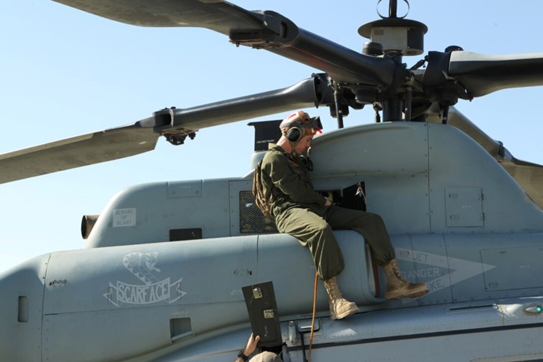 A Marine with Marine Light Attack Helicpoter Squadron 367 performs routine maintanence on a UH-1Y Huey before conducting a TRAP mission at the Combat Center’s Expeditionary Airfield July 30, 2013. 