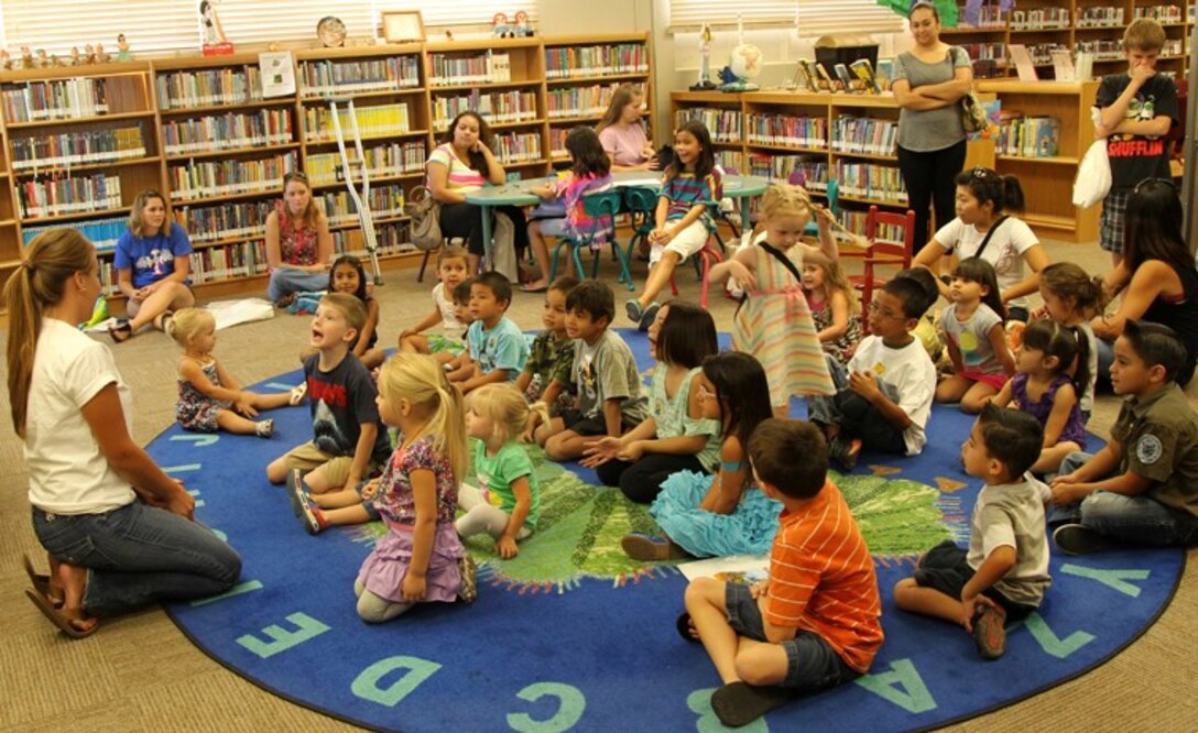 Ursula Morales, program coordinator, Lifelong Learning Library, leads summer reading program participants in singing songs during the last day of the program at the library, Aug. 9, 2013. Kids of all ages were invited to take part in the seven-week reading program at the library.
