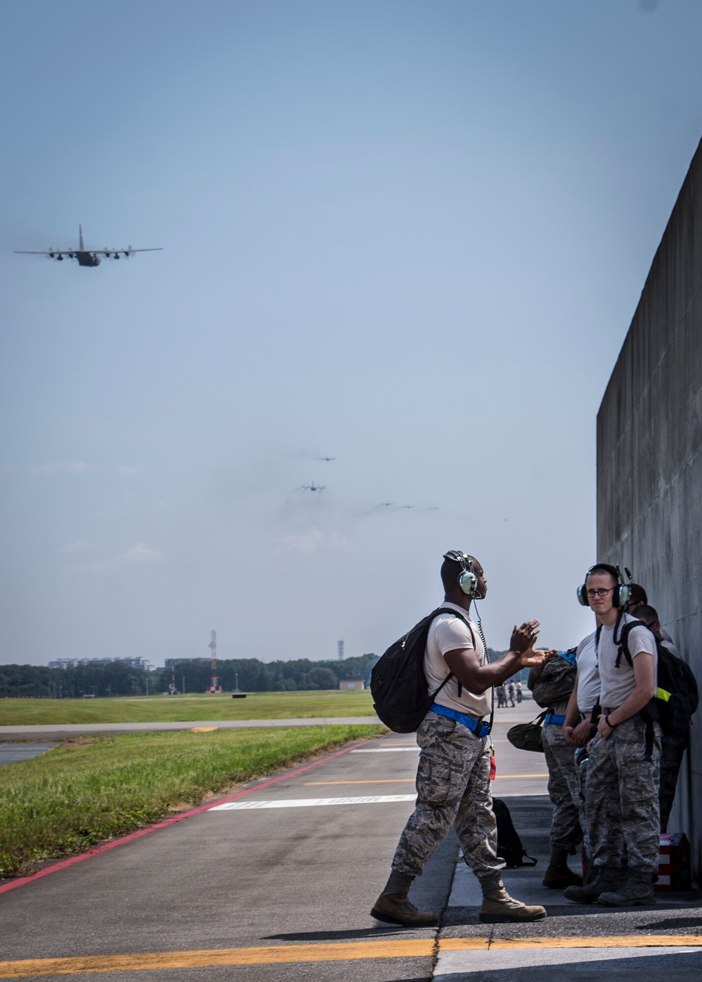 Maintainers assigned to the 374th Aircraft Maintenance Squadron celebrate as the final Yokota C-130 Hercules takes off during a large formation mission Aug. 19, 2013, at Yokota Air Base, Japan. Maintainers provide vital support to Yokota’s airlift mission. (U.S. Air Force photo by Captain Raymond Geoffroy)
