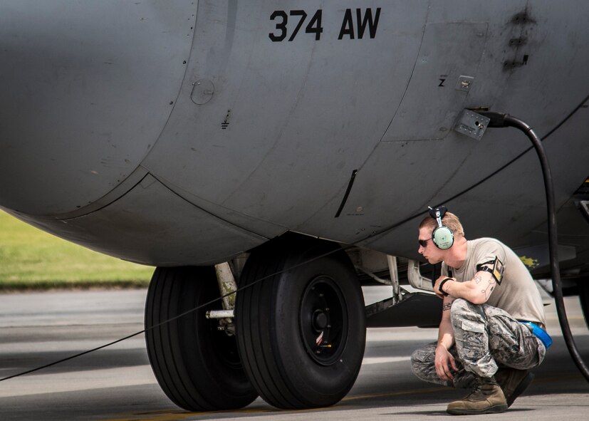 Airman 1st Class Robert Tucker, 374th Aircraft Maintenance Squadron maintainer, inspects his C-130 Hercules one last time before a large formation mission Aug. 19, 2013, at Yokota Air Base, Japan. The success of Yokota’s airlift mission is based on the dedicated, professional efforts of the entire 374th Airlift Wing. (U.S. Air Force photo by Captain Raymond Geoffroy)