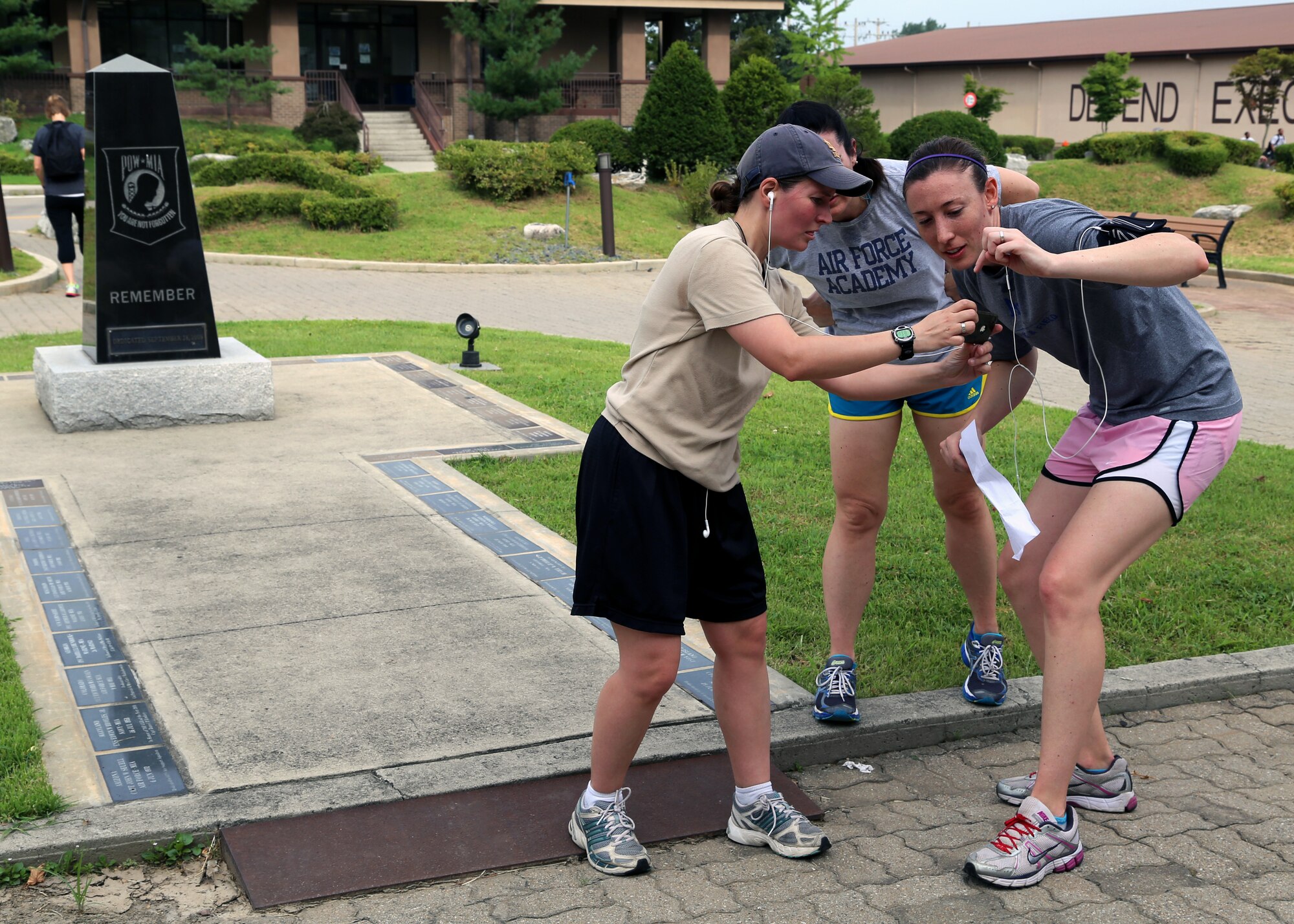A team of participants takes a picture of themselves at the Prisoner of War/Missing in Action Memorial during the first annual “Mustang Stampede” base scavenger hunt at Osan Air Base, Republic of Korea, Aug. 17, 2013. The POW/MIA memorial was one of eight landmarks that each team had to take a picture with. (U.S. Air Force photo/Senior Airman Samantha Konieczny)