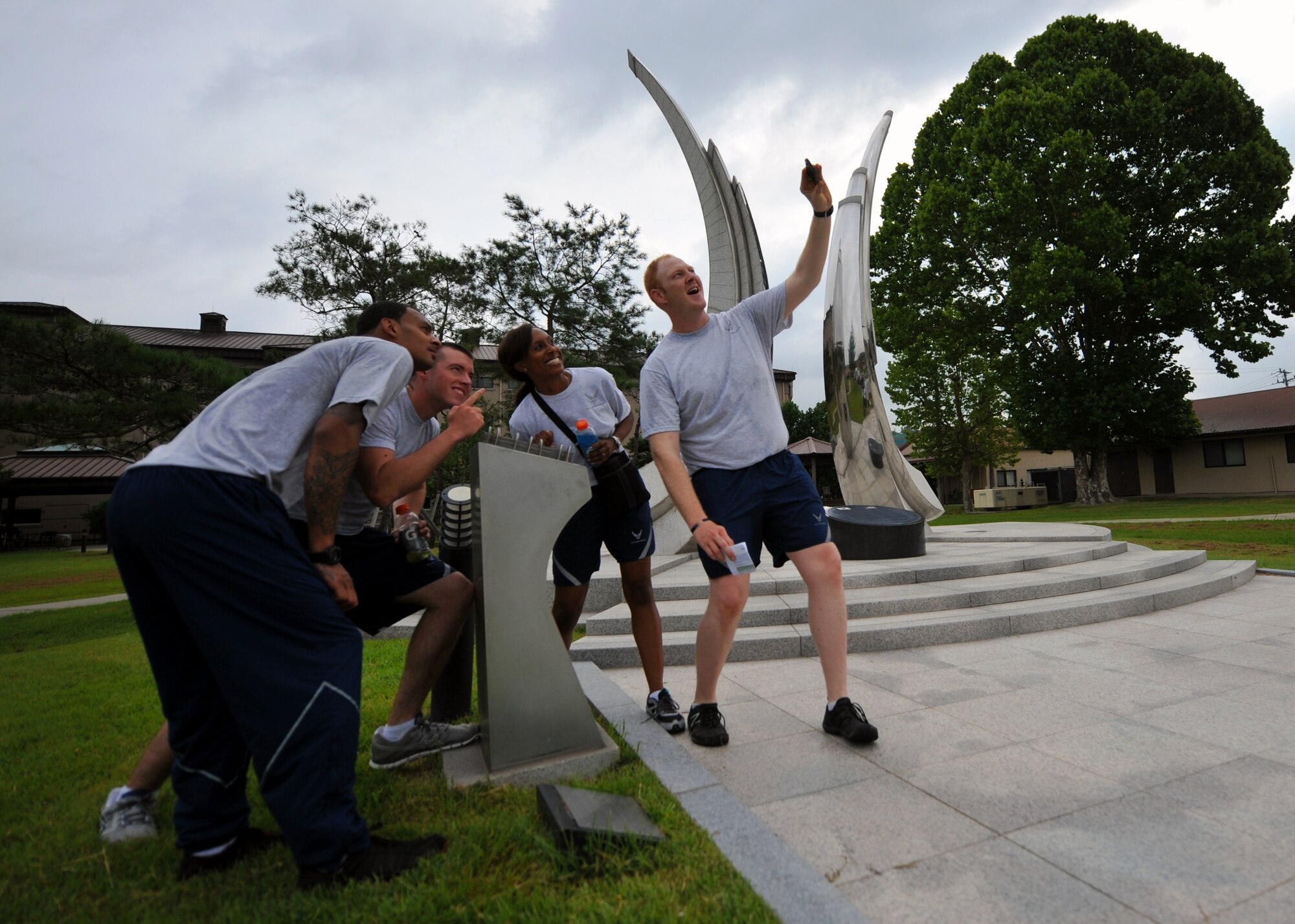 A team of participants take a picture of themselves during the first annual “Mustang Stampede” base scavenger hunt at Osan Air Base, Republic of Korea, Aug. 17, 2013. During the timed scavenger hunt, teams had to take pictures of themselves at eight different landmarks without using vehicles to get around the base. (U.S. Air Force photo/Senior Airman Samantha Konieczny)
