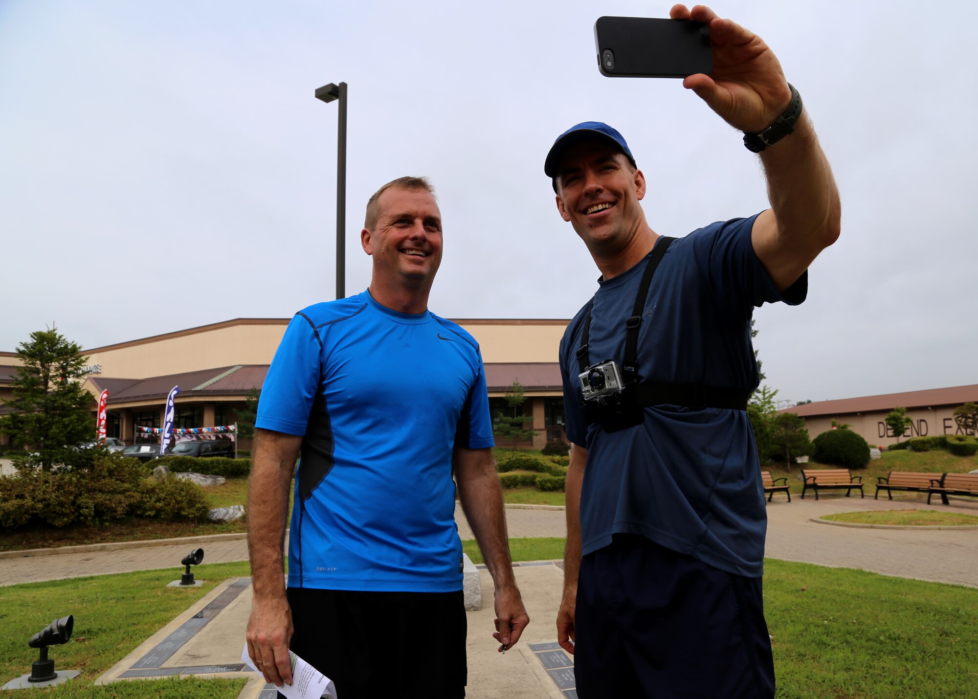 Col. James Clark, 51st Operations Group commander, and Col. Brook Leonard, 51st Fighter Wing commander, take a picture of themselves during the first annual “Mustang Stampede” base scavenger hunt at Osan Air Base, Republic of Korea, Aug. 17, 2013. For the scavenger hunt, each team of participants had to take a picture of themselves at eight different landmarks around the base, with the winner being the team that completed the hunt in the shortest amount of time. (U.S. Air Force photo/Senior Airman Samantha Konieczny)