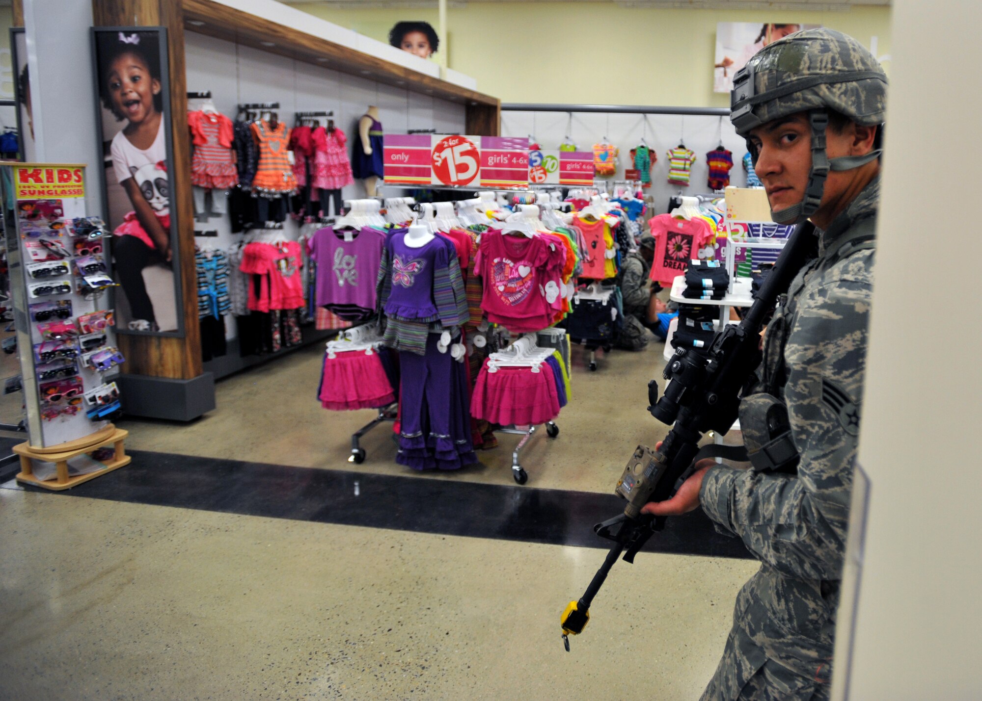 Senior Airman James Hogan, 51st Security Forces Squadron member, looks around a corner at the Exchange during high a risk response training scenario at Osan Air Base, Republic of Korea, Aug. 16, 2013. The scenario was part of a five-day course that is designed to help Airmen prepare to meet dangerous and unpredictable situations on military installations that require immediate law enforcement action. (U.S. Air Force photo/Senior Airman Siuta B. Ika)