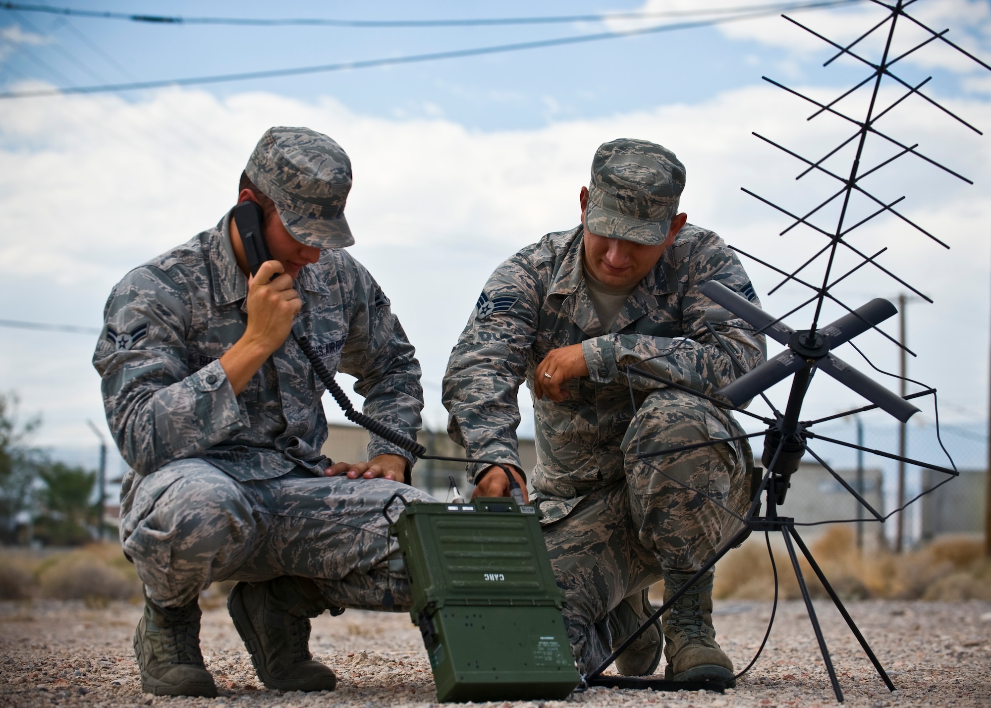 Airman 1st Class Anthony Giampapa and Senior Airman Brandon Lopez, 99th Communications Squadron radio frequency transmissions systems journeymen, operate a mobile ground radio satellite system Aug. 15, 2013, at Nellis Air Force Base, Nev. The 99 CS Airmen utilize mobile systems while at home station or deployed. (U.S. Air Force photo/Senior Airman Brett Clashman)