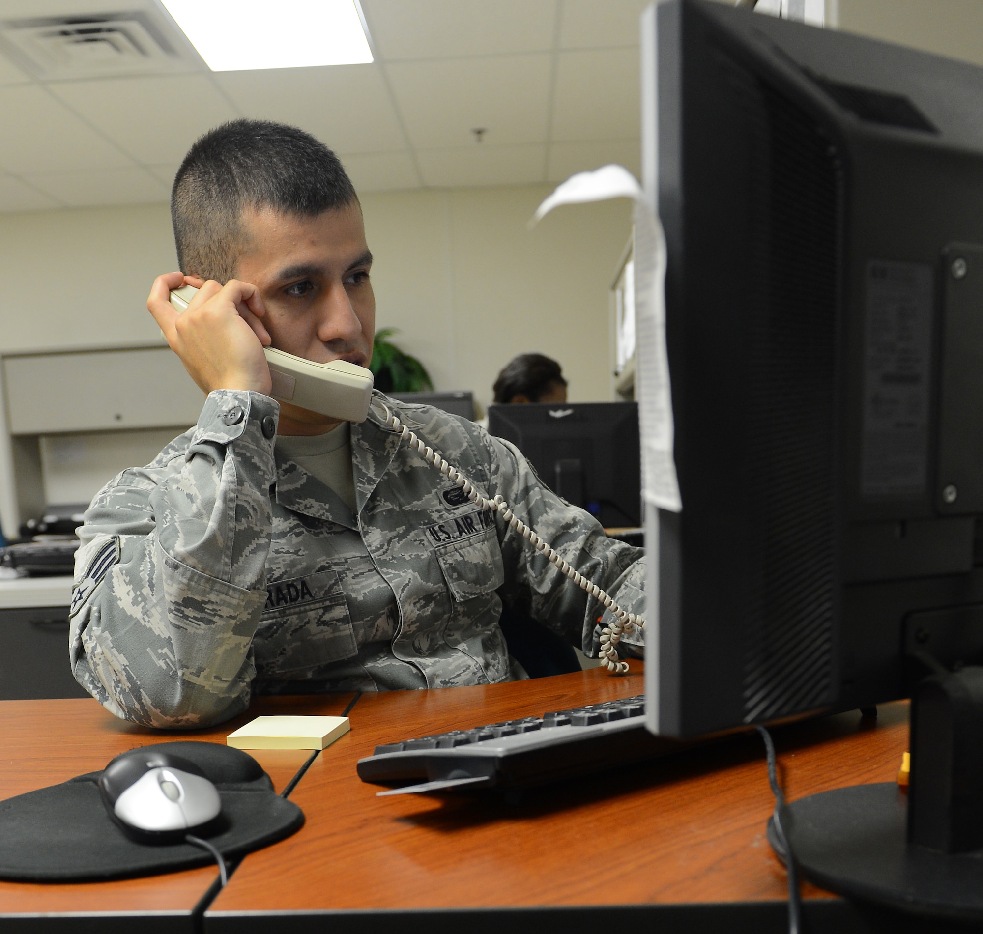 Senior Airman Julio Estrada, 2nd Force Support Squadron outbound assignments counselor, assists a customer on Barksdale Air Force Base, La., Aug. 19, 2013. Outbound assignments Airmen assist active duty military members and their families with base outprocessing for primary change of station and deployments. (U.S. Air Force photo/Senior Airman Micaiah Anthony)
