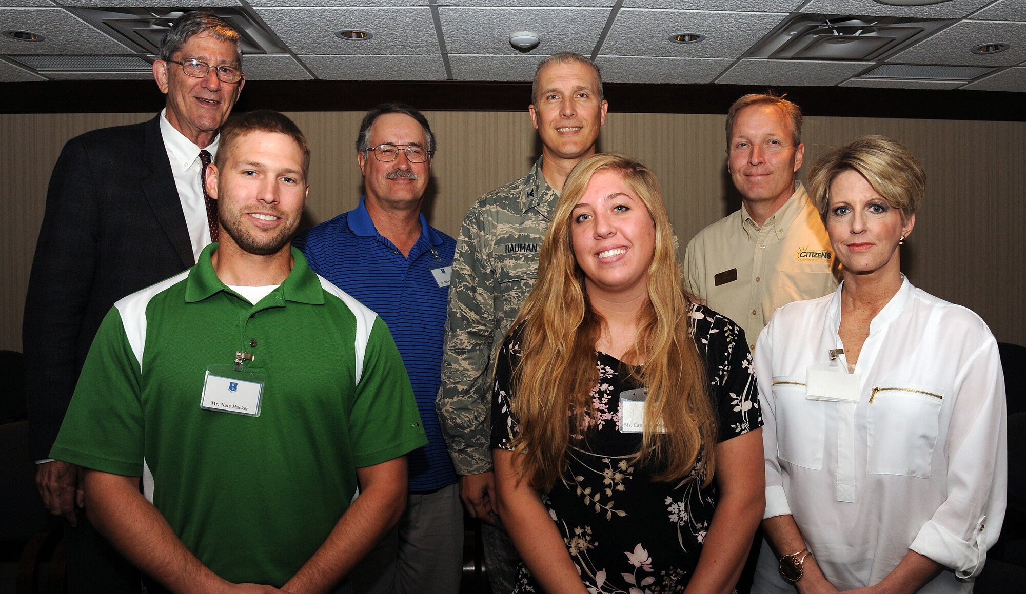 Col. Paul Bauman, 319th Air Base Wing commander, stands alongside members of the Habitat for Humanity board, Aug. 9, 2013 on Grand Forks Air Force Base, N.D. The board members were taken on a guided tour of the base where they were able to meet with the base commander to discuss the work volunteers from the base do for their organization in the city of Grand Forks, N.D. (U.S. Air Force photo/Airman 1st Class Zachiah Roberson)