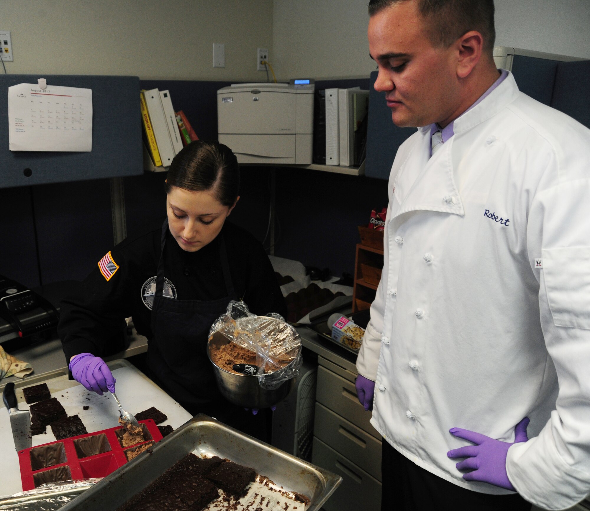 Army Sgt. Nicole Kanyer, U.S. Army Priority Air Transport flight steward, and Staff Sgt. Robert Stroh, 1st Airlift Squadron flight attendant, make a dessert during a joint culinary training session on Joint Base Andrews, Md., Aug. 14, 2013. Army flight stewards and Air Force flight attendants conducted a training class to obtain and develop new culinary skills from one another. (U.S. Air Force photo/Airman 1st Class Erin O’Shea) 
