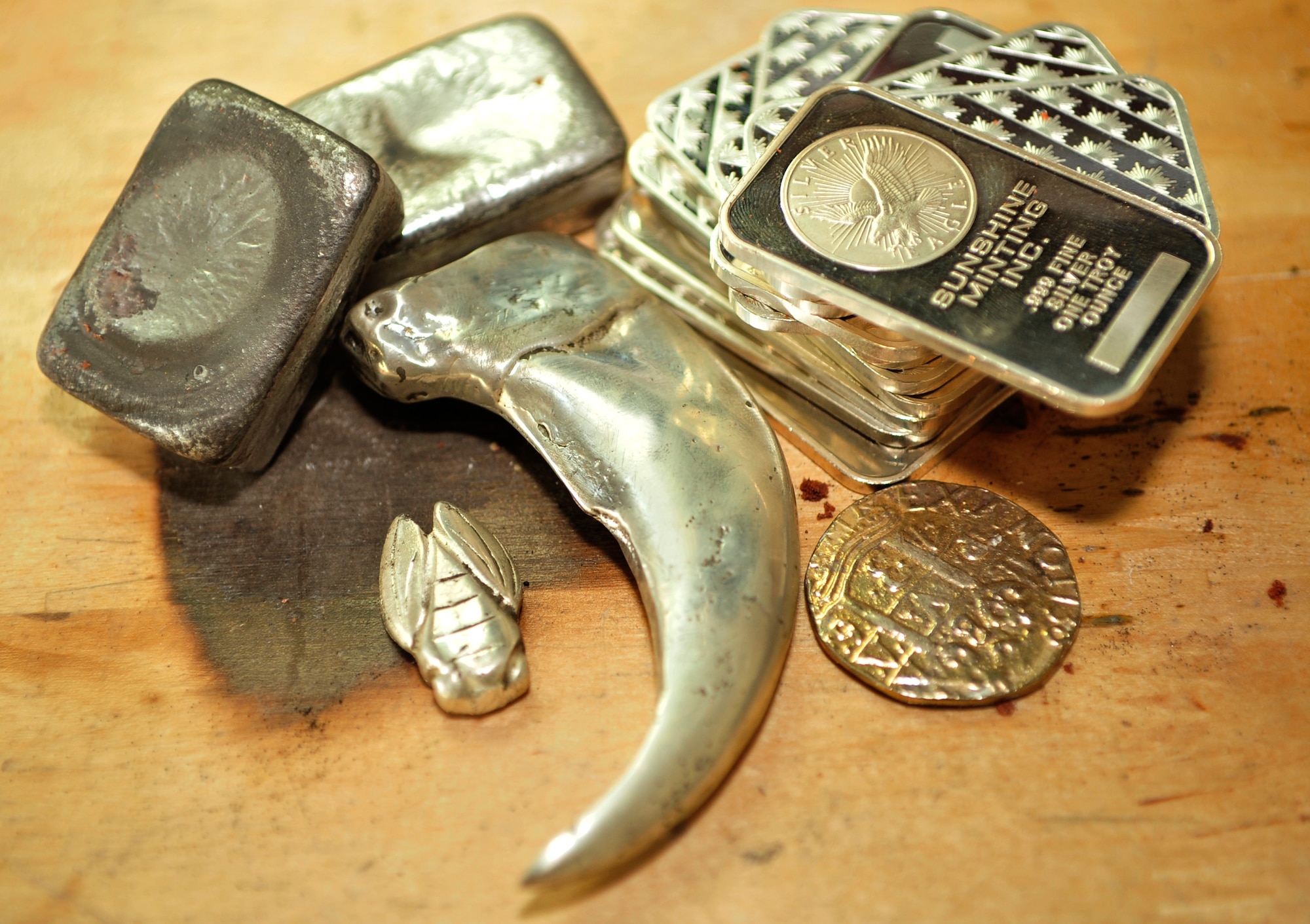 Many materials are used in the process of casting items from silver – molds are made from using clay, sand and an object of another material to make a hollow replica of the object. After a mold is complete, molten silver can be poured in and formed into the object. Chunks of silver are melted down into molten silver. (U.S. Air Force photo by Airman 1st Class Sarah Breer/released)