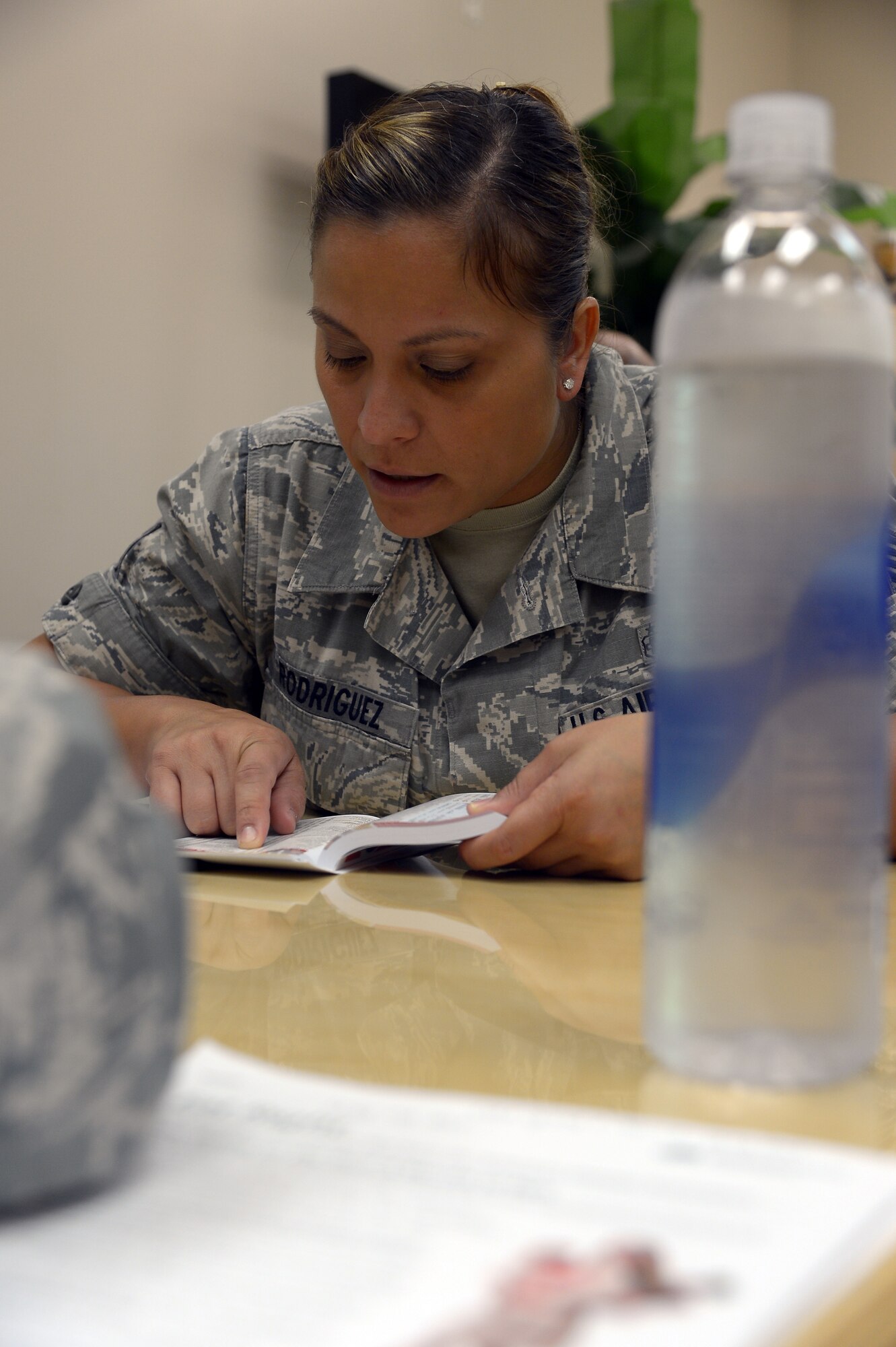 Tech. Sgt. Jazmin Rodriguez, 6th Air Mobility Wing, looks up the amount of calories and fat in a fast food meal during the “Better Body, Better Life” class at MacDill Air Force Base Fla., August 15, 2013. Rodriguez also planned out a healthy restaurant meal that stayed within her calorie budget as part of the class. (U.S. Air Force photo by Airman 1st Class Tori Schultz/Released/cropped to point of interest)