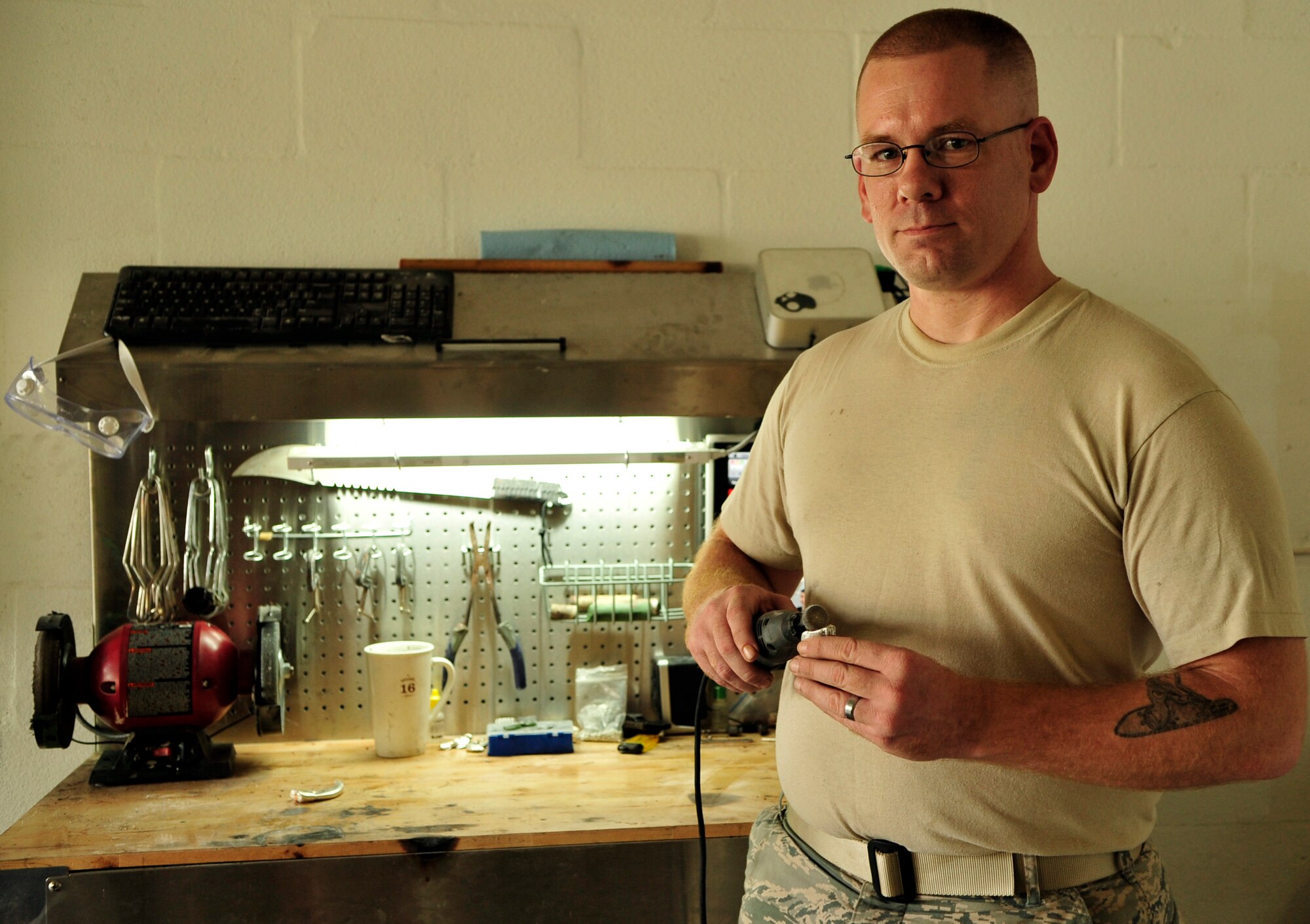 Staff Sgt. James Ebbs, 6th Communications Squadron network infrastructure supervisor, works from his home in Tampa, Fla. casting items from silver. He has made many small items before, but had never been asked to make an urn before. A family in the Midwest asked him to contain their seven-year-old son’s ashes in twin urns made of silver – a humbling experience for Ebbs. (U.S. Air Force photo by Airman 1st Class Sarah Breer/released)