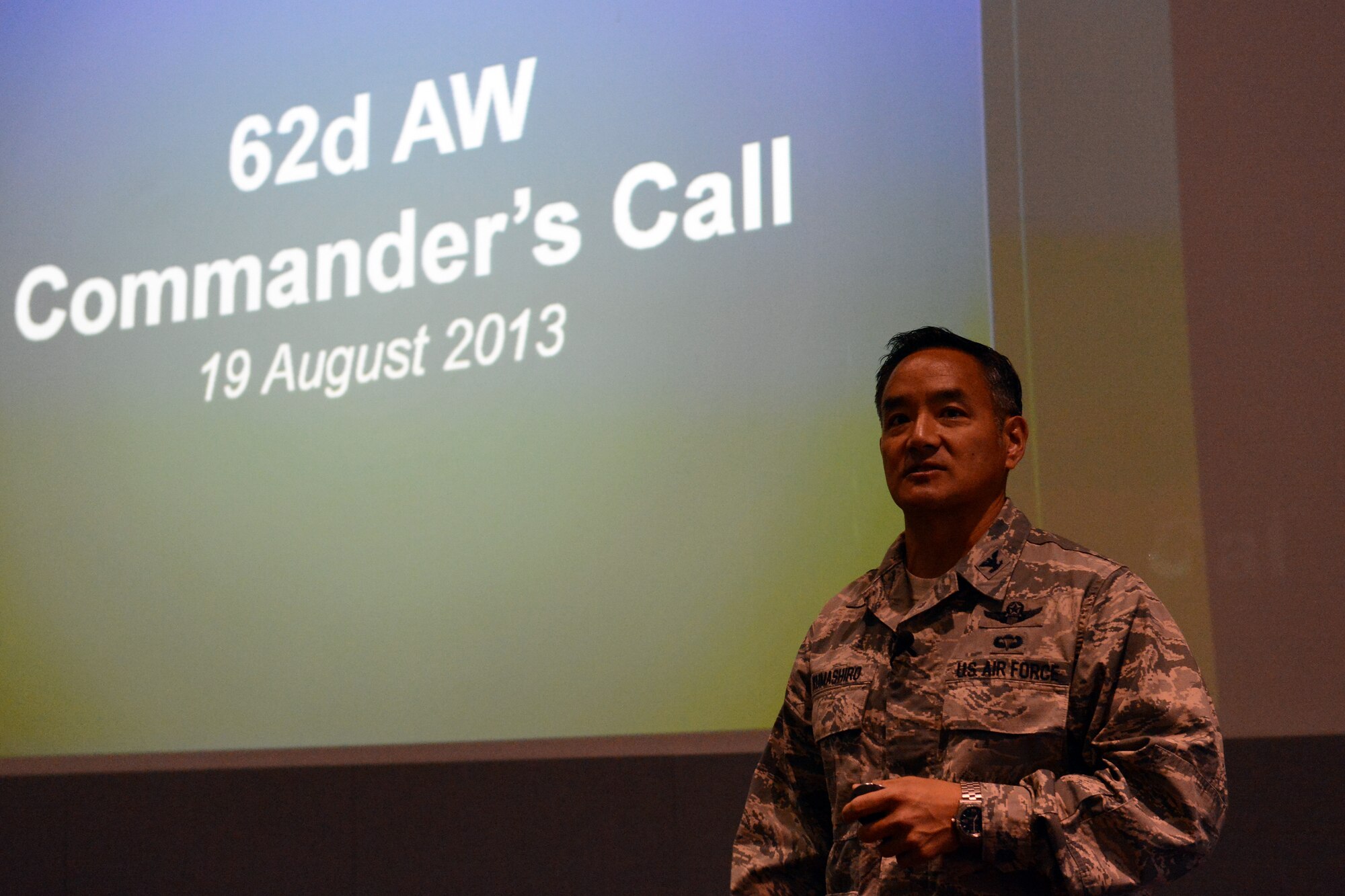 Col. David Kumashiro, 62nd Airlift Wing commander, hosts his first commander’s call, Aug. 19, 2013, at the McChord Theater at Joint Base Lewis-McChord, Wash.  Kumashiro discussed issues with Airmen from the 62nd AW concerning sexual assault prevention, developing a culture of dignity and respect, and working as a team for mission success. (U.S. Air Force Photo/Airman 1st Class Jacob Jimenez)