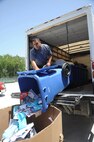 Gerardo Gutierrez, JBSA-Randolph Recycling Center technician, transfers paper prior to recycling Aug. 8. (U. S. Air Force photo by Don Lindsey)
