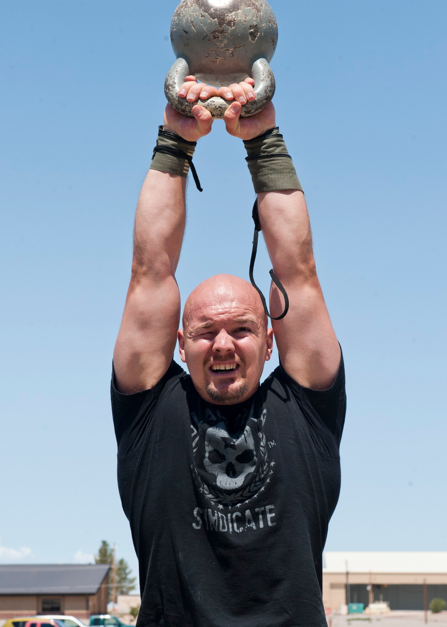 An Airman lifts a weight above his head as a part of the “Fittest Wingman Challenge” at Holloman Air Force Base, N.M., Aug. 16. The Fittest Wingman Challenge was part of Comprehensive Airman Fitness Day which encouraged a total fitness approach to well-being. This quarters CAF day was focused on physical fitness, members of Team Holloman participated in a wing run, followed by various sporting events.  Participants learned the importance of physical activity and comradery. (U.S. Air Force photo by Airman 1st Class Daniel E. Liddicoet/Released)


