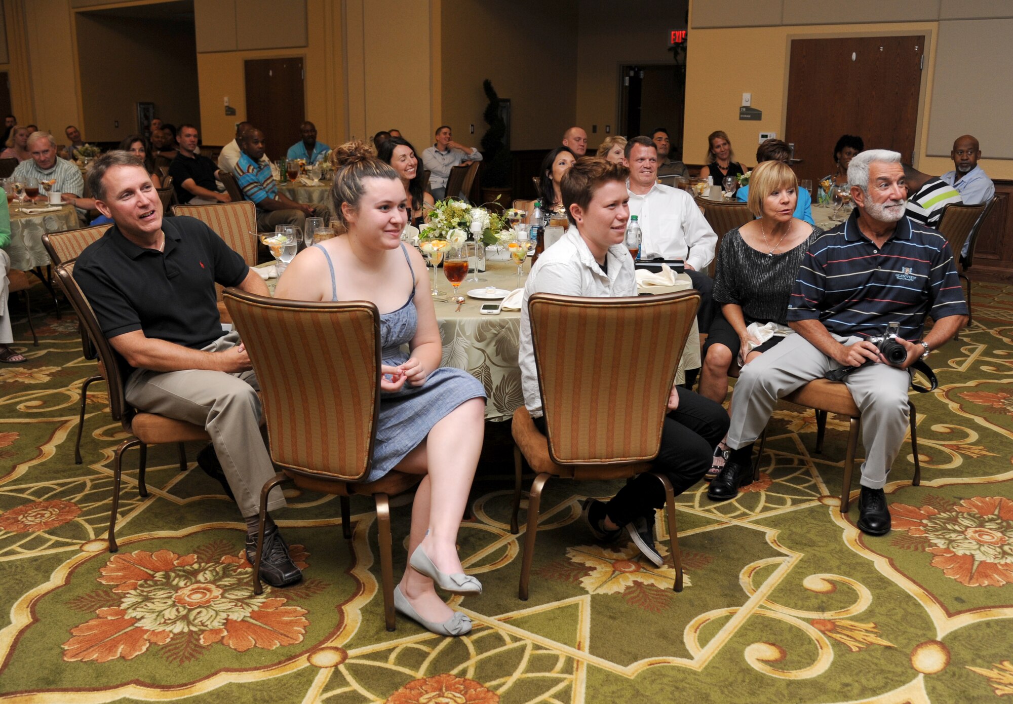 Family members of Chief Master Sgt. Angie Johnson, 81st Training Wing command chief, sit at the head table during the Johnson’s farewell dinner Aug. 15, 2013, at the Bay Breeze Event Center, Keesler Air Force Base, Miss. Johnson leaves Keesler to become the command chief for Air Force Space Command’s Space and Missile Systems Center, Los Angeles Air Force Base, Calif.  (U.S. Air Force photo by Kemberly Groue)