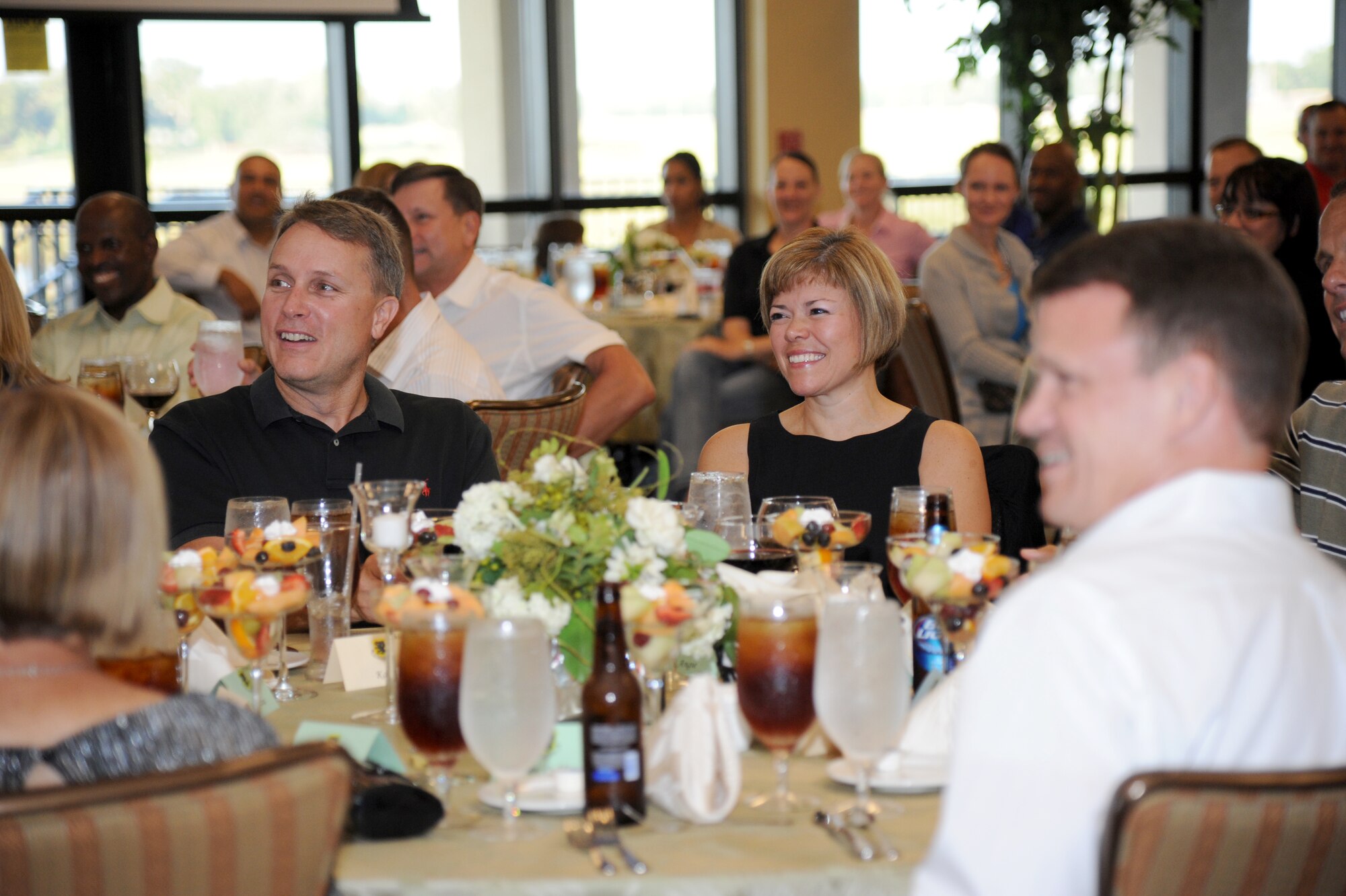 Chief Master Sgt. Angie Johnson, 81st Training Wing command chief, smile during introductions at the Johnson’s farewell dinner Aug. 15, 2013, at the Bay Breeze Event Center, Keesler Air Force Base, Miss. Johnson leaves Keesler to become the command chief for Air Force Space Command’s Space and Missile Systems Center, Los Angeles Air Force Base, Calif.  (U.S. Air Force photo by Kemberly Groue)