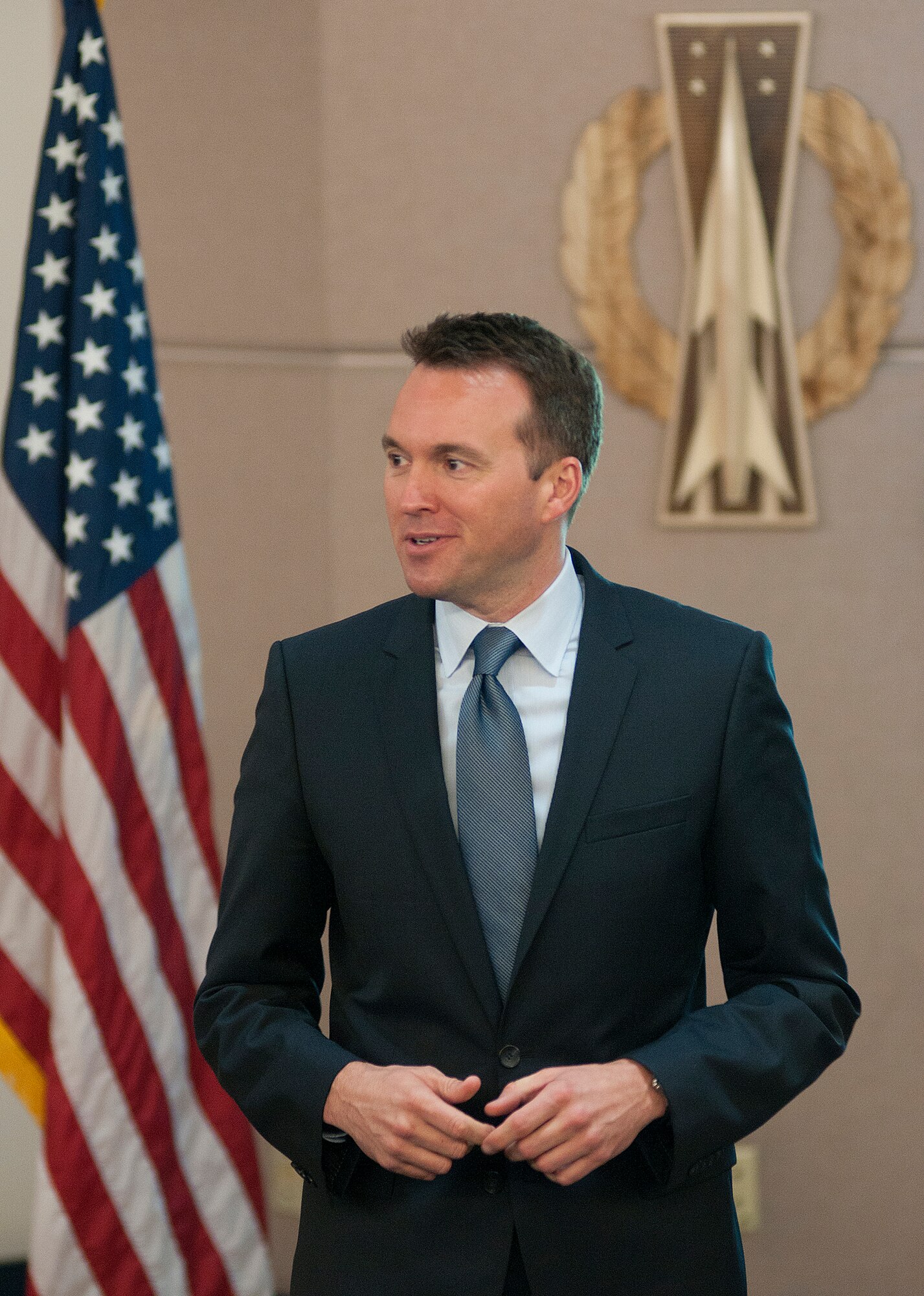 Acting Secretary of the Air Force Eric Fanning, speaks with 90th Missile Wing missile combat crews during a visit to F.E. Warren Air Force Base, Wyo., Aug. 16, 2013. Fanning visited with the 90th Operations Group Airmen following their mass brief before they headed out to the missile field. The emblem on the wall is a replica of the missile operator badge worn by the missile crews. (U.S. Air Force photo by R.J. Oriez)