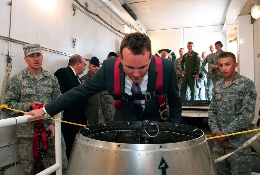 Acting Secretary of the Air Force Eric Fanning, takes a look into a Minuteman III re-entry system during a visit to F.E. Warren Air Force Base, Wyo., Aug. 15, 2013. Fanning is wearing a safety harness as he leans over the open missile silo of the 90th Missile Wing Minuteman III training launch facility. Staff Sgts. Christopher Graham and Nicholas Kolja, 90th Maintenance Operations Squadron, briefed Fanning on the operations and capabilities of a payload transporter used to transport and maintain nuclear assets. (U.S. Air Force photo by R.J. Oriez)