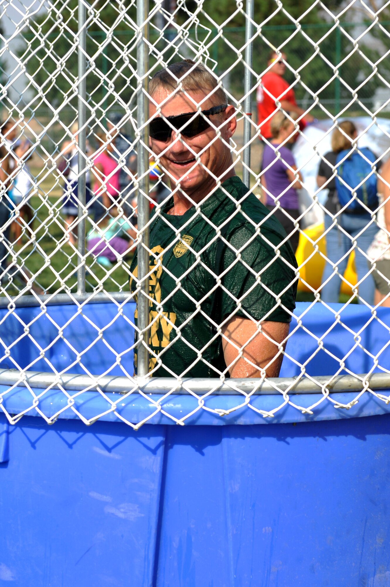 Chief Master Sgt. Craig Hall, 460th Space Wing command chief, rises up in the dunk tank after being immersed in water the during Fun Fest Aug. 16, 2013, at the softball fields on Buckley Air Force Base, Colo. The 460th Space Wing celebrated its ninth birthday with Fun Fest, a day filled with sport competitions and a community fair. (U.S. Air Force photo by Airman 1st Class Riley Johnson/Released)