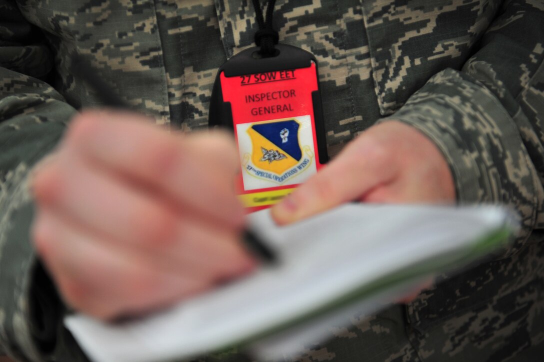 A member of the 27th Special Operations Wing Inspector General marks down his reviews during an exercise Aug. 16, 2013 at Cannon Air Force Base, N.M. The exercise gave the Cannon Fire Department, emergency medical personnel and Security Forces personnel a chance to fine-tune their skills in emergency response to an on base occurrence. (U.S. Air Force photo/ Tech. Sgt. Josef Cole)  