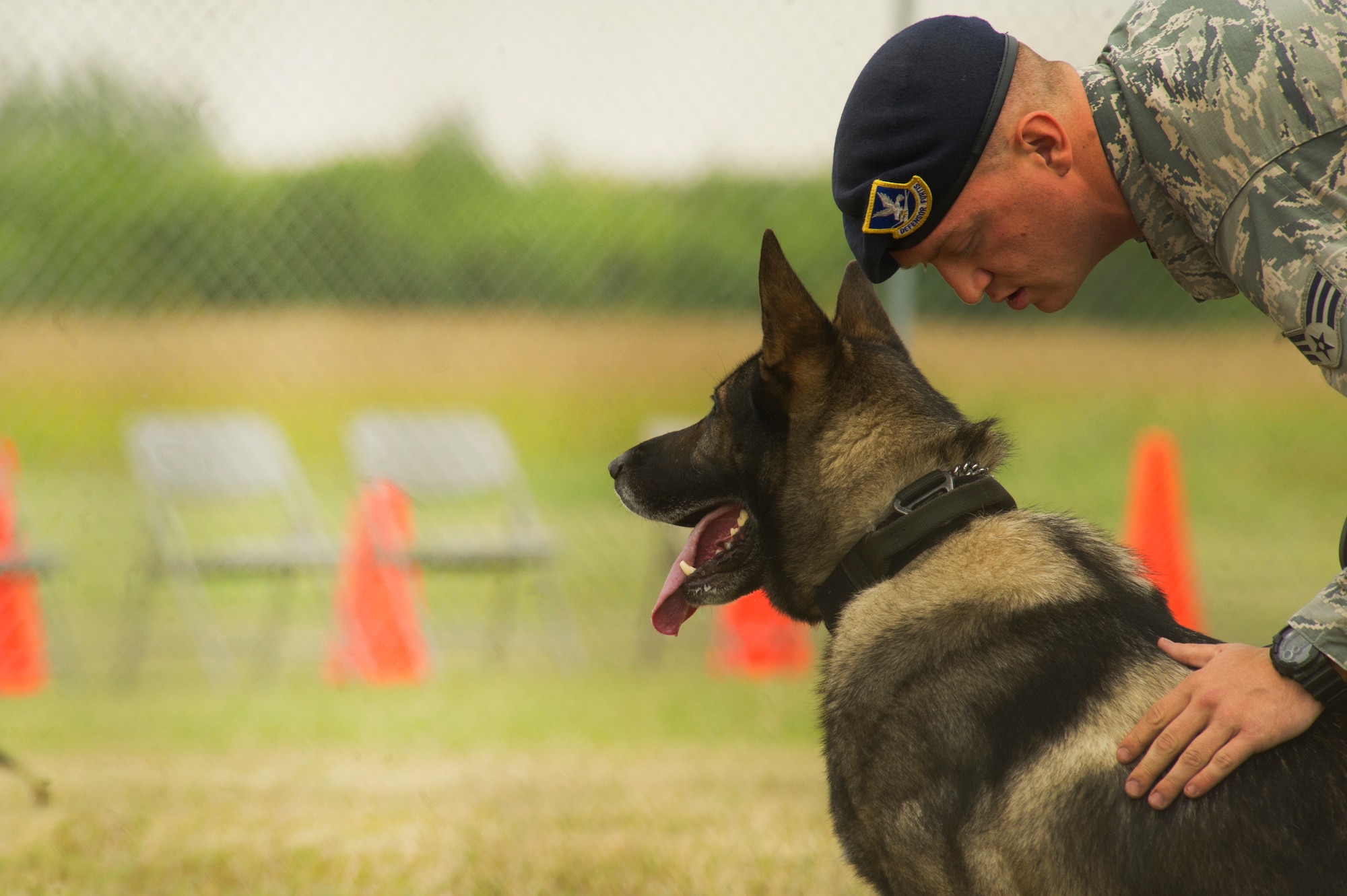 Senior Airman Zachary Fredrick, 5th Security Forces Squadron Military Working Dog  handler, and MWD  Roko compete in the 2013 North Dakota Peace Officer Association K-9 Police Trials at Minot Air Force Base, N.D., Aug. 14, 2013. The trials included narcotics and explosive search competitions, as well as the Iron Dog event . (U.S. Air Force photo/Senior Airman Brittany Y. Auld)