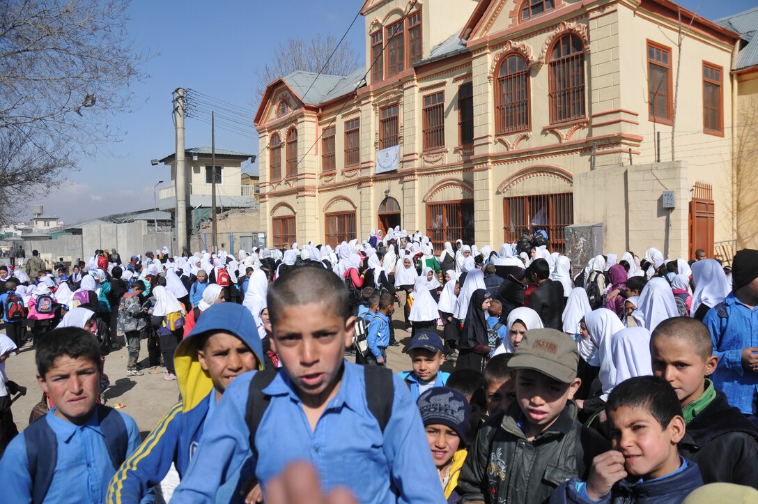 Retired Lt. Gen. John Bradley, and wife Jan, founders of the Lamia Afghan Foundation, worked to renovate an old school for 3,000 children in Kabul. King Amanullah Khan built a large house for his sister in 1920. It has become Amir Dost Mohammad Khan School. Bradley found the dynamic in this image comical but typical, “Where the boys run to the camera and but the girls run to the school.” (Courtesy photo)