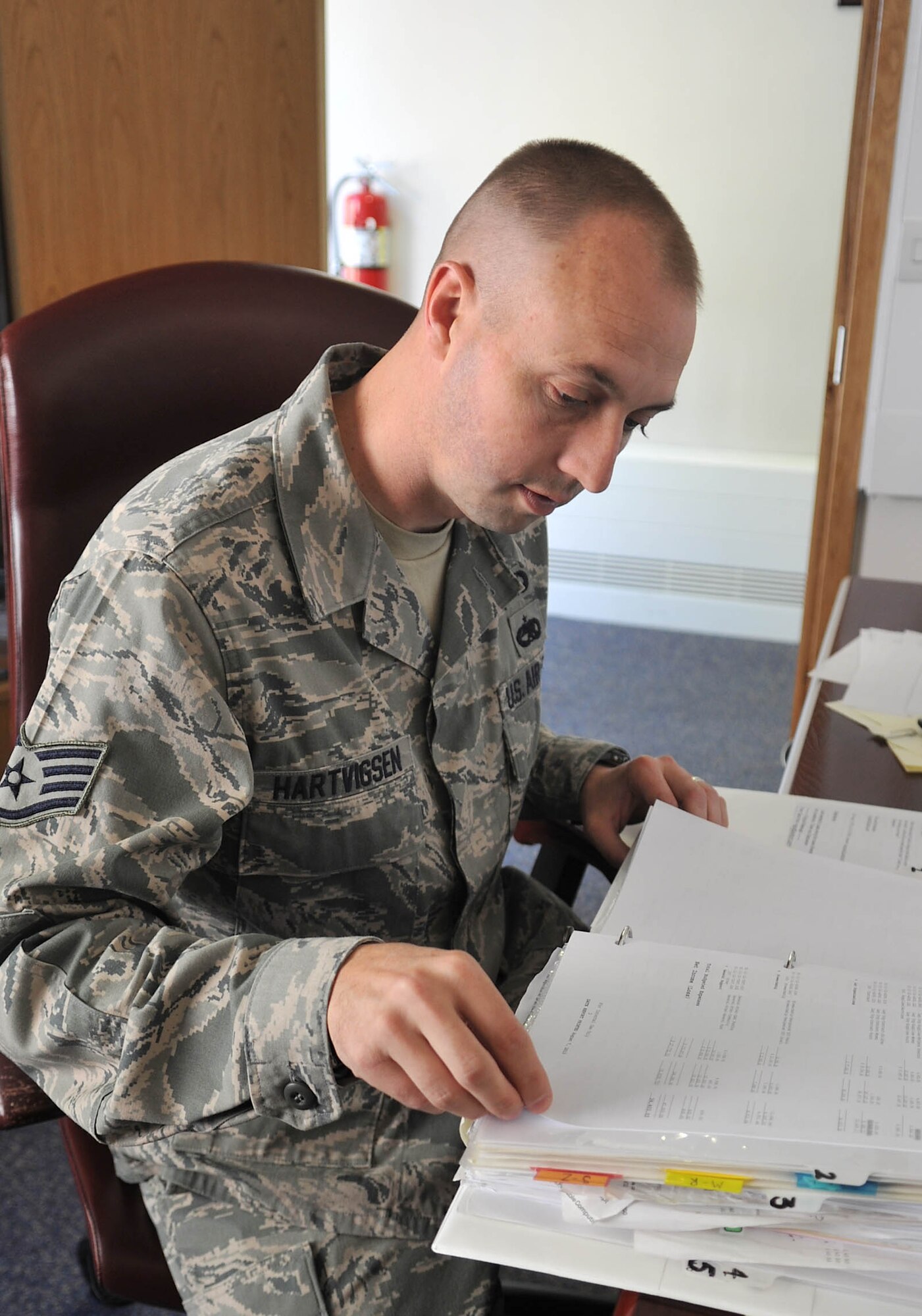 U.S. Air Force Staff Sgt. Joshua Hartvigsen, 100th Air Refueling Wing chapel NCO in charge of readiness and training from Bountiful, Utah, reviews chapel finance records Aug. 8, 2013, in the base chapel on RAF Mildenhall, England. Chaplain’s assistants not only handle the logistics of the church, but assist with services of every faith the chapel hosts.  The job of being a chaplain’s assistant is only available to enlisted Airmen. (U.S. Air Force photo by Airman 1st Class Kyla Gifford/Released)