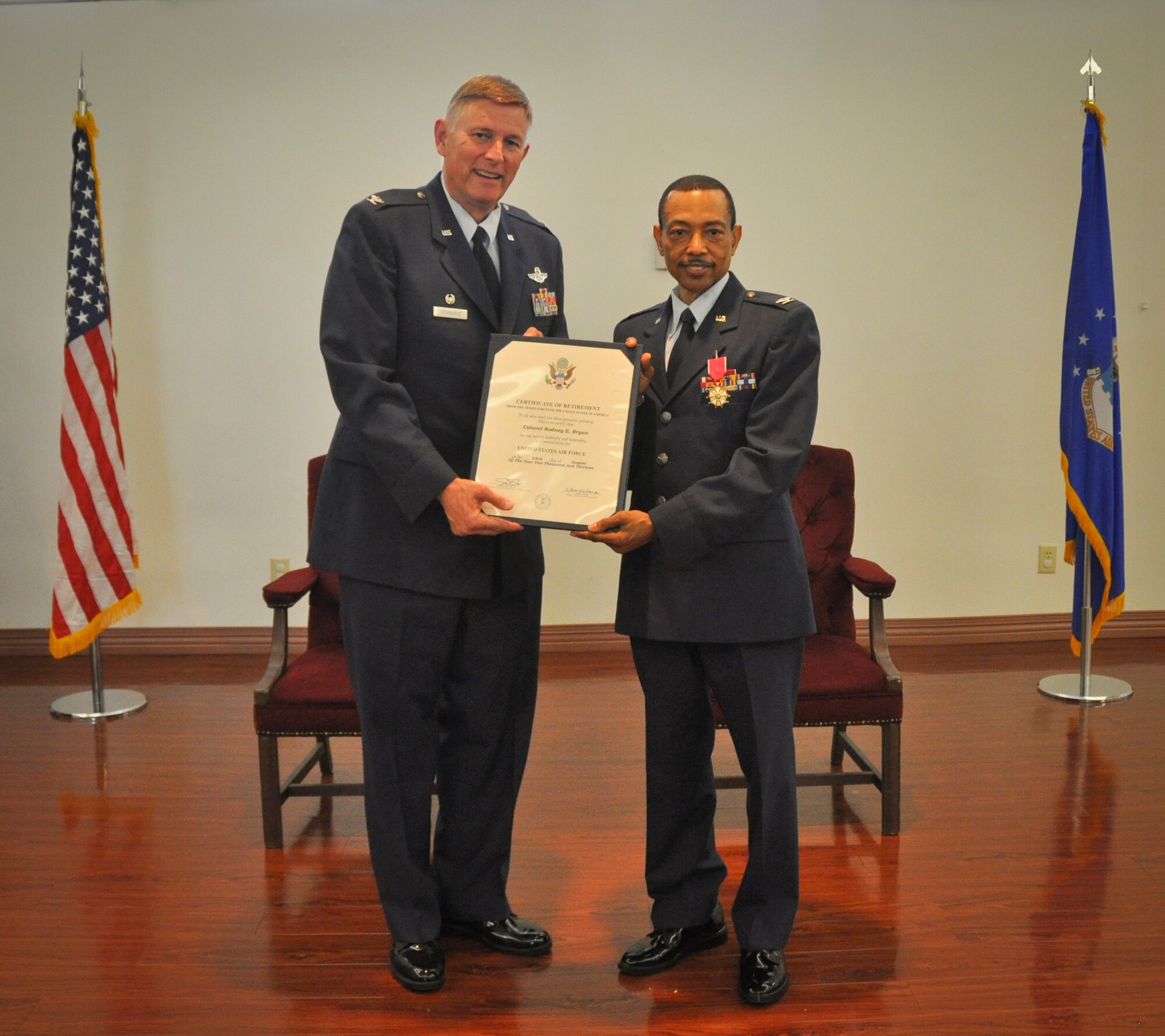 MACDILL AIR FORCE BASE, Fla. – Col. Douglas Schwartz, left, presents Col. Rodeny Bryan, with his retirement certificate during a ceremony here Aug. 3, 2013.  Bryan ended a 38-year career with the Air Force as the commander of the 927th Mission Support Group and special advisor to the commander.  (Official U.S. Air Force photo/Tech. Sgt. Shawn Rhodes)