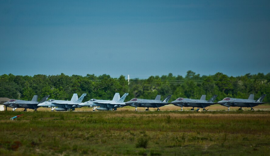 All three F-35 Lightning II variants along with two F/A-18 Hornets line up at the end of the runway prior to take off Aug. 14 at Eglin Air Force Base, Fla.  This was the first time all three had been in the air at the same time over Eglin.  To date, the Air Force, Marine Corps and the Navy have flown more than 2,000 sorties here.  (U.S. Air Force photo/Samuel King Jr.)