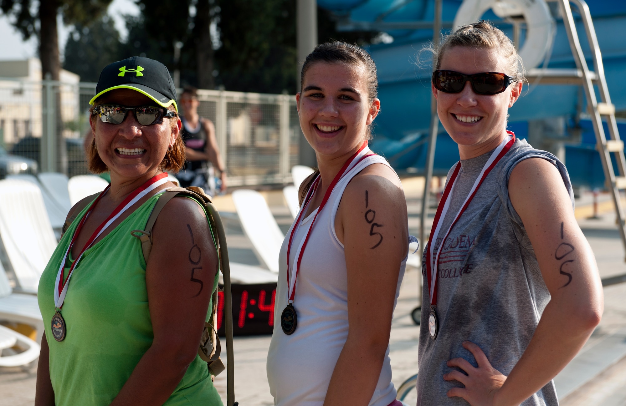 The third place team of the Incirlik sprint triathlon, Kellie Ruthford, Denise Wright and Laura Rosenweig; show off their medals Aug. 17, 2013, at Incirlik Air Base, Turkey. The event consisted of a 5K run, a 20K bike ride and 200 meter swim. (U.S. Air Force photo by Senior Airman Daniel Phelps/Released)