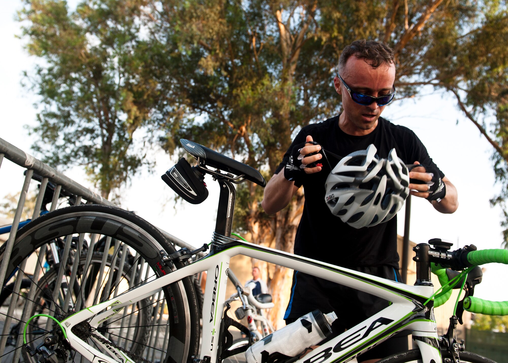 An Incirlik triathlon participant takes off his bike helmet during the sprint triathlon to prepare for the swim portion Aug. 17, 2013, at Incirlik Air Base, Turkey. The athletes raced as either teams or individuals covering a 5K run, 20K bike ride and 200 meter swim. (U.S. Air Force photo by Senior Airman Daniel Phelps/Released)
