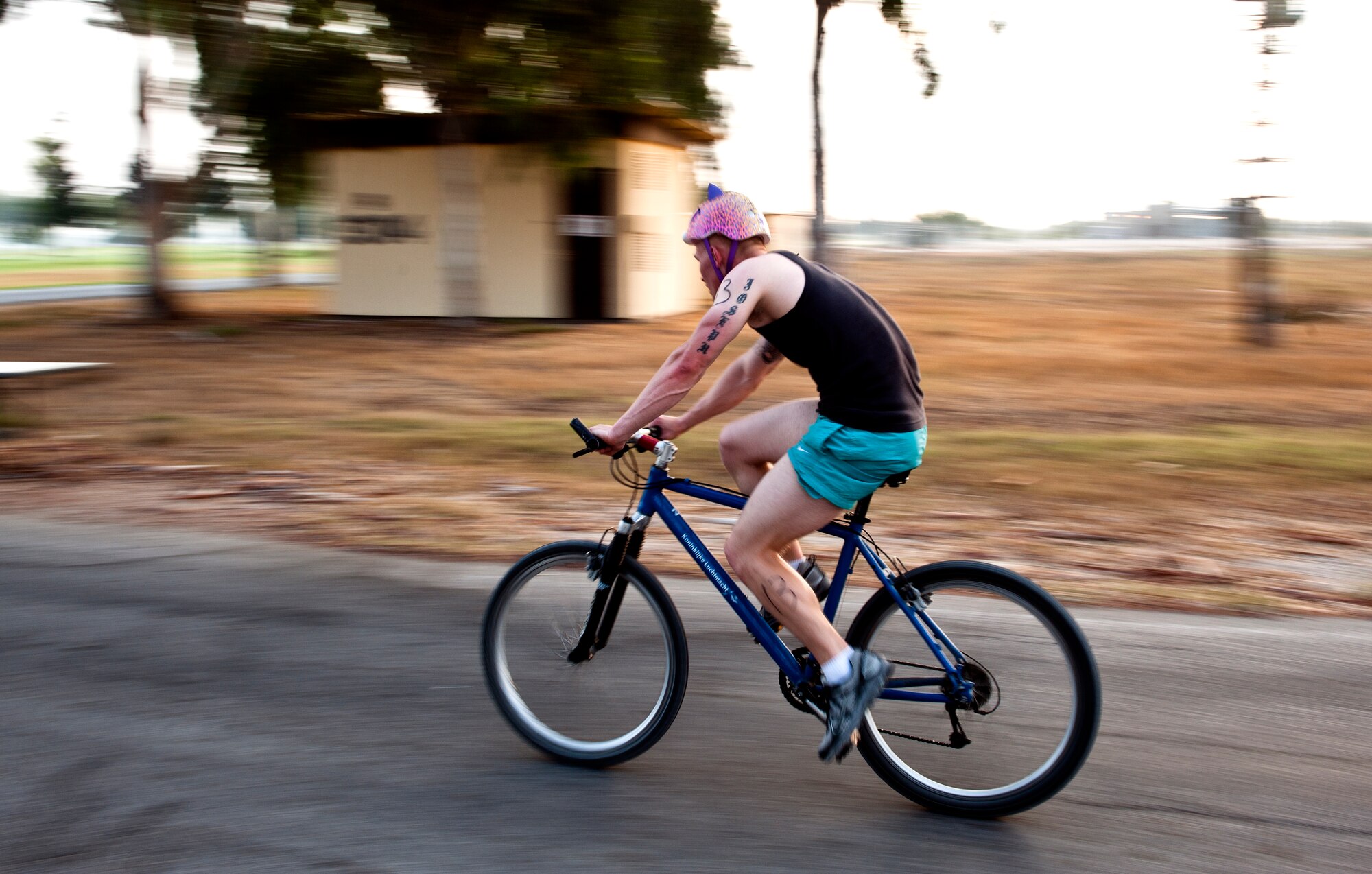 An Incirlik triathlon participant rides his bicycle around a corner during the bike portion of the triathlon Aug. 17, 2013, at Incirlik Air Base, Turkey. The bike portion of the race was 20 kilometers long. (U.S. Air Force photo by Senior Airman Daniel Phelps/Released)