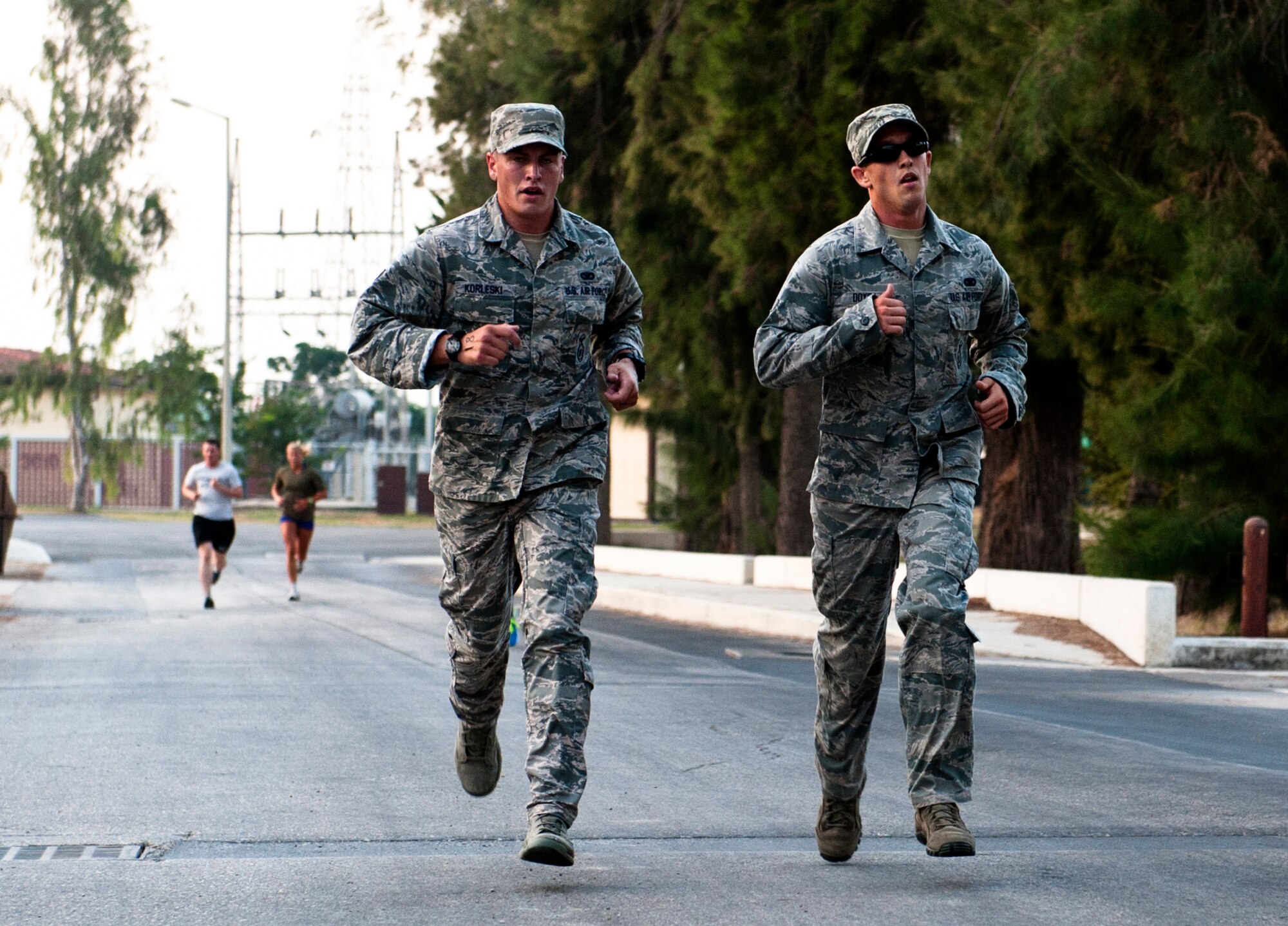 Christopher Korleski and Dustin Doyea run the 5K portion of the sprint triathlon in their Airman Battle Uniform Aug. 17, 2013, at Incirlik Air Base, Turkey. Korleski and Doyea competed in their ABUs as a way to honor fallen security forces members. (U.S. Air Force photo by Senior Airman Daniel Phelps/Released)