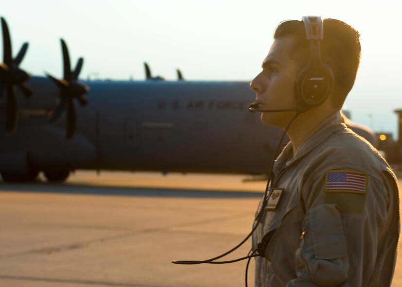 U.S. Air Force Senior Airman Ramon Granados, 39th Airlift Squadron loadmaster, looks on as a C-130J turns on its engines Aug. 10, 2013, at Dyess Air Force Base, Texas. With this being the first 317th Airlift Group deployment supporting U.S. Africa Command in several years, leadership at the 39th AS views the trip as a learning and growing opportunity they wouldn’t have at other locations. (U.S. Air Force photo by Airman 1st Class Peter Thompson/Released)