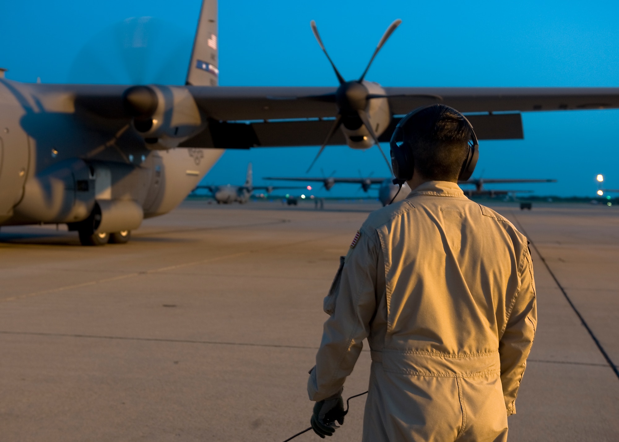 U.S. Air Force Senior Airman Ramon Granados, 39th Airlift Squadron loadmaster, looks on as a C-130J turns on its engines Aug. 10, 2013, at Dyess Air Force Base, Texas. This is the first time in more than two years that the 317th Airlift Group has supported U.S. Africa Command. Most recently, in early 2011, the group provided one of their first C-130Js in support of operations in North Africa. (U.S. Air Force photo by Airman 1st Class Peter Thompson/Released)